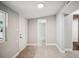 Bright hallway leads to bathroom with tiled shower, combining function with style at 717 Frank Lloyd Wright Way, Lakeland, FL 33803