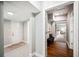 Welcoming hallway featuring hardwood floors, a bench, and access to multiple rooms at 717 Frank Lloyd Wright Way, Lakeland, FL 33803