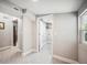 Bright hallway with hexagon tile floor leading to the laundry room and other areas at 717 Frank Lloyd Wright Way, Lakeland, FL 33803