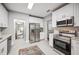 Modern kitchen with stainless steel appliances, granite countertops, and white cabinets at 717 Frank Lloyd Wright Way, Lakeland, FL 33803