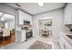 Modern kitchen featuring white cabinets, stainless steel appliances, and a view of the dining area at 717 Frank Lloyd Wright Way, Lakeland, FL 33803