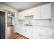Kitchen with white cabinets, marble counters, subway tile backsplash and stainless steel refrigerator at 717 Frank Lloyd Wright Way, Lakeland, FL 33803