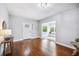 Open living room featuring hardwood floors and a decorative front door at 717 Frank Lloyd Wright Way, Lakeland, FL 33803