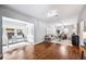 Bright living room with hardwood floors, neutral walls, and an adjacent office and dining area at 717 Frank Lloyd Wright Way, Lakeland, FL 33803