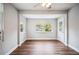 Living room with wood-look floors, large windows and light gray walls at 717 Frank Lloyd Wright Way, Lakeland, FL 33803