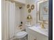 Bathroom with white vanity, gold fixtures, and bathtub with shower at 733 Carpenters Way # 36, Lakeland, FL 33809