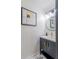 Bathroom vanity with dark cabinets, light countertop, gold fixtures and unique mirror decor at 733 Carpenters Way # 36, Lakeland, FL 33809