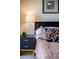 Modern bedroom with stylish nightstand, elegant lamp, and contemporary artwork creating an inviting atmosphere at 733 Carpenters Way # 36, Lakeland, FL 33809