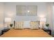 Cozy bedroom featuring patterned pillows, stylish decor, and bedside lamps providing a warm and inviting atmosphere at 733 Carpenters Way # 36, Lakeland, FL 33809