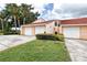 Well-maintained villa featuring two-car garage and lush landscaping, showcasing curb appeal and convenient parking at 733 Carpenters Way # 36, Lakeland, FL 33809