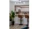 Well-lit kitchen features white cabinets, stainless steel appliances, and bar seating at 733 Carpenters Way # 36, Lakeland, FL 33809