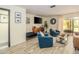 Bright living room with a decorative mirror, stylish furniture, and a view of the screened patio at 733 Carpenters Way # 36, Lakeland, FL 33809