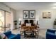 Stylish living room showcasing tile floors, chic furniture, and access to the screened-in patio at 733 Carpenters Way # 36, Lakeland, FL 33809