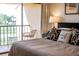 Inviting main bedroom with balcony access, showcasing stylish furniture and decor creating an elegant and tranquil retreat at 733 Carpenters Way # 36, Lakeland, FL 33809