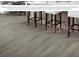 Wood-style flooring featuring white barstools underneath a large island with overhang at 7550 Sw 108Th St, Ocala, FL 34476
