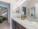 Bathroom with double sinks, ample counter space, and a view into an adjacent bedroom with eye-catching decor at 7562 Sw 108Th St, Ocala, FL 24476