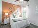 Bright bedroom with a comfortable bed, decorative wall art, and a ceiling fan at 7562 Sw 108Th St, Ocala, FL 24476