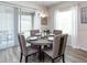 Modern dining room featuring a round table, stylish chairs, and an elegant light fixture near a sliding glass door at 7562 Sw 108Th St, Ocala, FL 24476