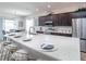 Modern kitchen with a large island, stainless steel appliances, and dark cabinets at 7562 Sw 108Th St, Ocala, FL 24476