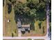Aerial view of property featuring lush greenery, a house with a separate garage, and boundary lines at 7721 Forest Way, Lakeland, FL 33810