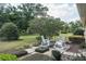 Relaxing backyard with a cozy seating area, rocking chairs and serene landscaping at 7721 Forest Way, Lakeland, FL 33810