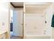Bathroom featuring tub and shower with white tiles; next to bedroom area at 7721 Forest Way, Lakeland, FL 33810