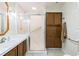 Bathroom features tiled shower, vanity with sink, and wooden cabinets at 7721 Forest Way, Lakeland, FL 33810
