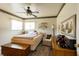 Bright bedroom featuring wood-look floors, a ceiling fan, and ample natural light at 7721 Forest Way, Lakeland, FL 33810