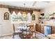 Cozy breakfast nook featuring a glass-top table and charming window treatments at 7721 Forest Way, Lakeland, FL 33810