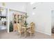Bright dining room featuring a glass-top table, ornate chairs, and a decorative chandelier at 7721 Forest Way, Lakeland, FL 33810