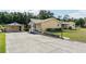 Charming ranch-style home featuring a long driveway, a detached garage and manicured landscaping at 7721 Forest Way, Lakeland, FL 33810