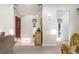 Light-filled foyer featuring a red front door and glimpses into the living and dining areas at 7721 Forest Way, Lakeland, FL 33810