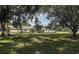 This single-story home features a large, lush front yard with mature trees at 7721 Forest Way, Lakeland, FL 33810
