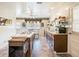 Open kitchen boasts wood cabinets, tiled floors, and a central island with cooktop and seating at 7721 Forest Way, Lakeland, FL 33810