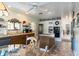 Wood cabinets, appliances, and view to pantry, cooktop island, and dining area at 7721 Forest Way, Lakeland, FL 33810