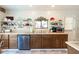Traditional kitchen featuring wood cabinets, stainless steel appliances, and decorative shelving at 7721 Forest Way, Lakeland, FL 33810