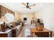 Inviting living room featuring wood-look floors, comfortable seating, and a ceiling fan at 7721 Forest Way, Lakeland, FL 33810