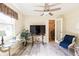 Bright sitting room with modern floors and an adjacent office area with ample light at 7721 Forest Way, Lakeland, FL 33810
