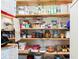 Pantry shelves featuring a variety of dry goods, cookware and appliances at 7721 Forest Way, Lakeland, FL 33810