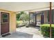 Covered patio with screened enclosure, offering a relaxing outdoor space with a view of the yard at 7721 Forest Way, Lakeland, FL 33810