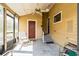 Covered patio featuring a ceiling fan, and access to the backyard and an entry door at 7721 Forest Way, Lakeland, FL 33810