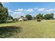 Expansive backyard showcasing the home's generous lot size with a long green lawn and mature trees at 7721 Forest Way, Lakeland, FL 33810