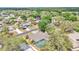 Aerial view of a home featuring a screened-in pool and mature trees at 7741 Merrily Way, Lakeland, FL 33809