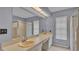 Bathroom featuring double sinks, a walk-in shower and natural lighting at 7741 Merrily Way, Lakeland, FL 33809