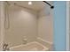 Bathtub with a shower head and tiled walls at 7741 Merrily Way, Lakeland, FL 33809