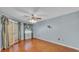 Bedroom featuring an overhead fan, access to the lanai, and natural lighting at 7741 Merrily Way, Lakeland, FL 33809