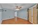 Bedroom featuring an overhead fan, access to the lanai, and doorway to another room at 7741 Merrily Way, Lakeland, FL 33809