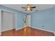 Bedroom with ceiling fan and open closet at 7741 Merrily Way, Lakeland, FL 33809