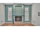 Living room with a large fireplace, tile floors, and green accent wall at 7741 Merrily Way, Lakeland, FL 33809