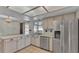 Neutral kitchen with stainless steel appliances, tile floor and ample counter space at 7741 Merrily Way, Lakeland, FL 33809